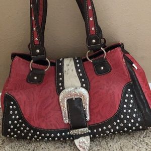 Red western purse with hair on strap.
